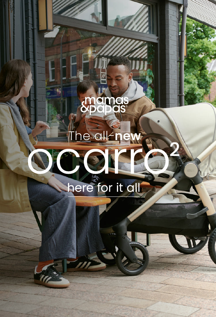 Family sitting at an outdoor cafe with a the Mamas & Papas Ocarro 2 Pram