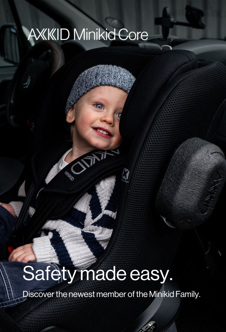 Child in a car seat with AXKID minikid core branding, featuring text 'Safety made easy.'